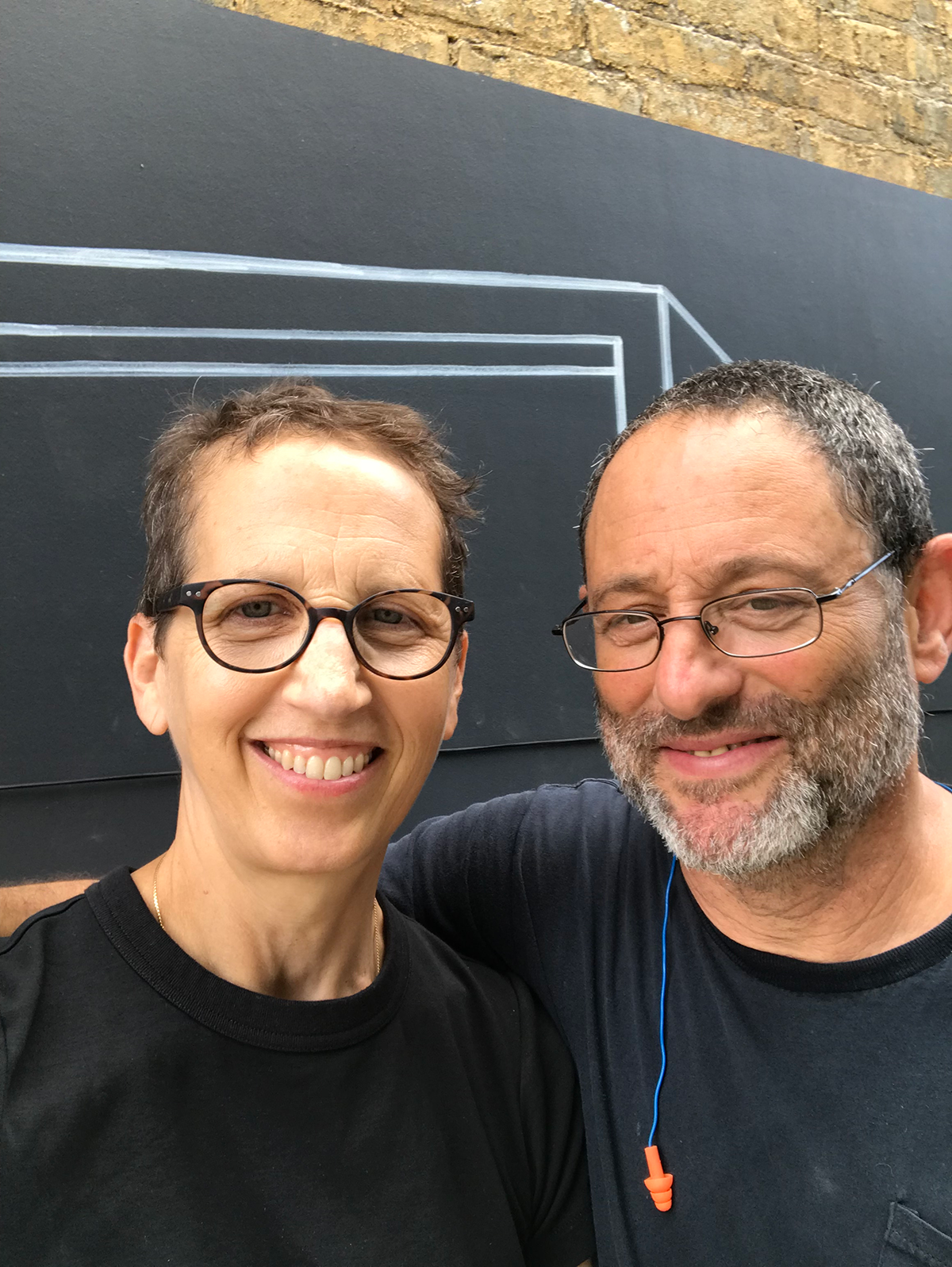 N Good and Julie Cowan in front of Mural