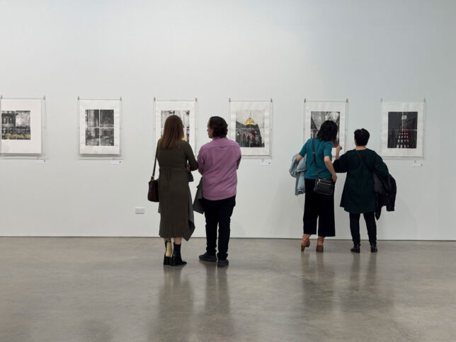 Opening of Julie Cowan lithographs at Rose Gallery with people looking at the art